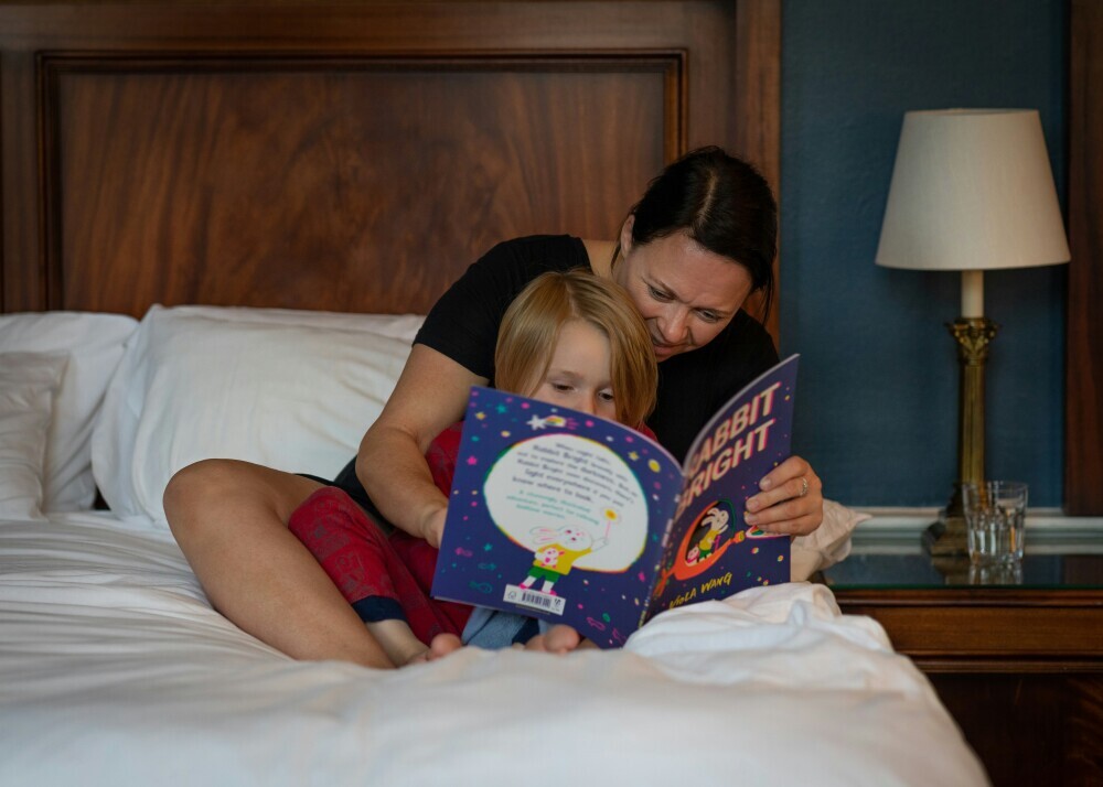 A parent reading a story book with a child