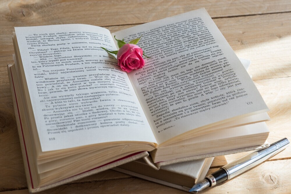 An open book with a flower on it