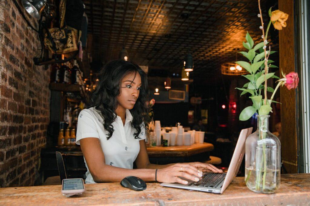 A woman in a cafe, working on her laptop