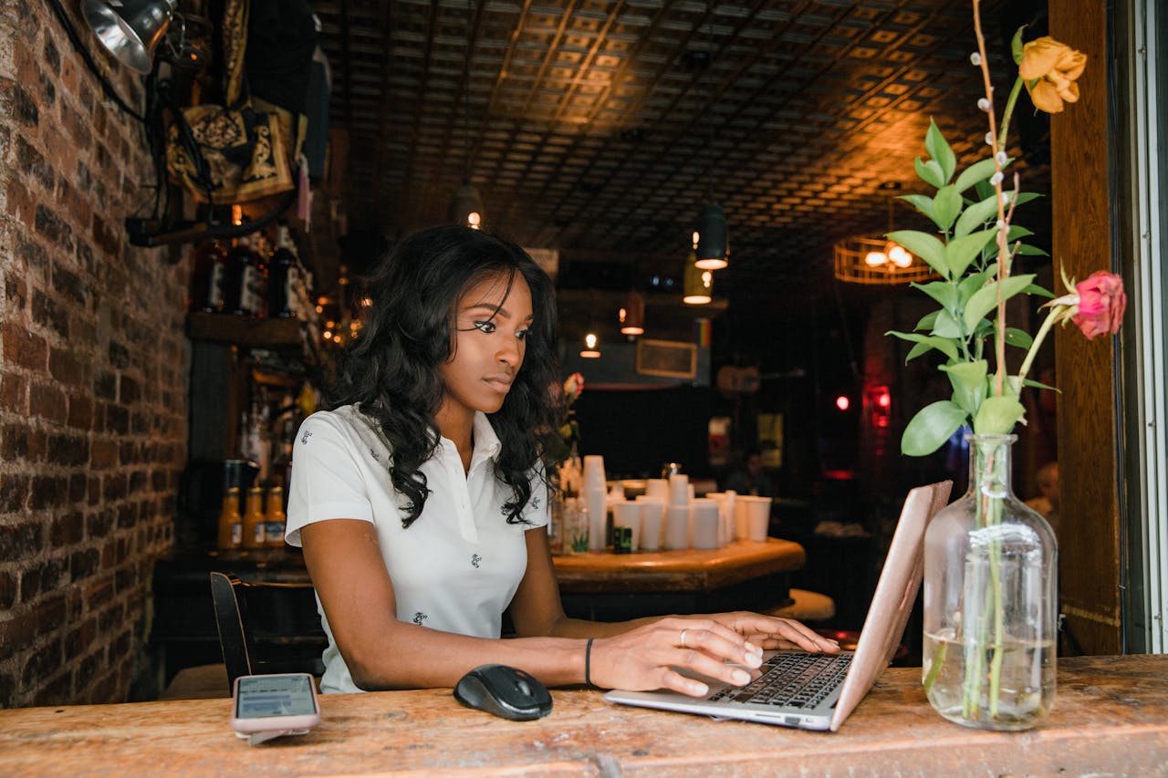 A woman in a cafe, working on her laptop